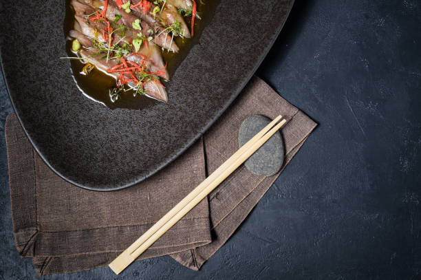 istock Sashimi tuna, carpaccio, black background, top view 1137508871