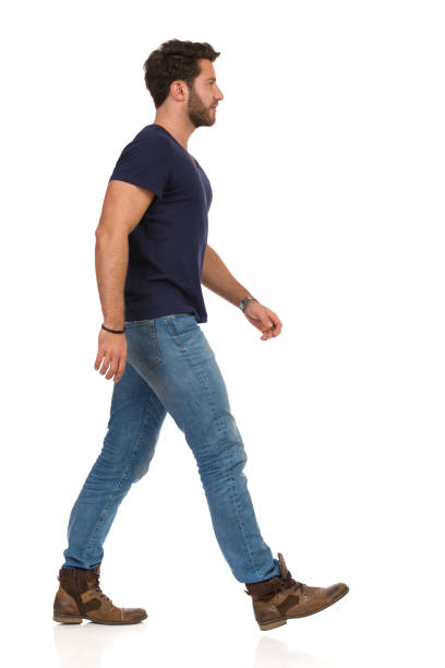 istock Man Walking In Blue T-shirt, Jeans And Boots 1137510436