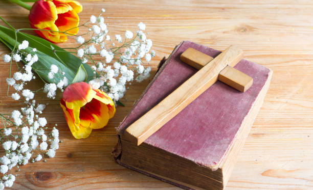 istock Spring easter flowers and cross on wooden background 1137512088
