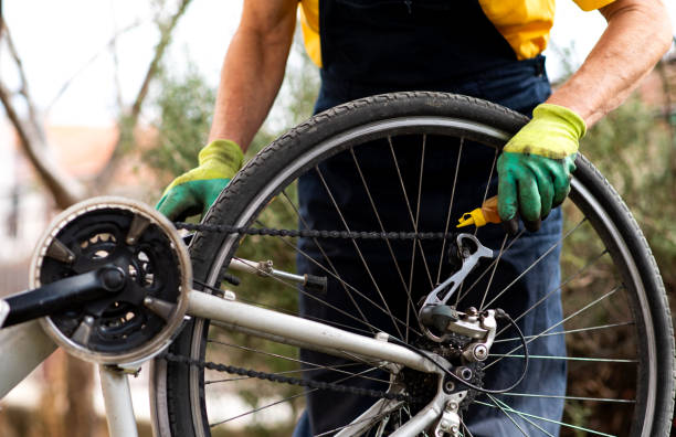 istock Man lubricating bicycle chain maintaining for the new season 1137514499