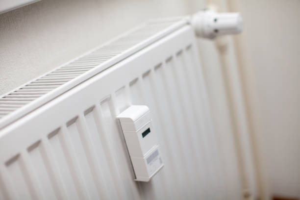 istock Modern white radiator with thermostat reduced to economy mode 1137516704