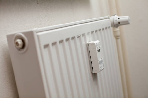 istock Modern white radiator with thermostat reduced to economy mode 1137516752
