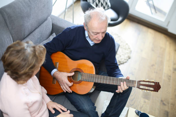 istock Senior man playing a guitar for his wife 1137517256