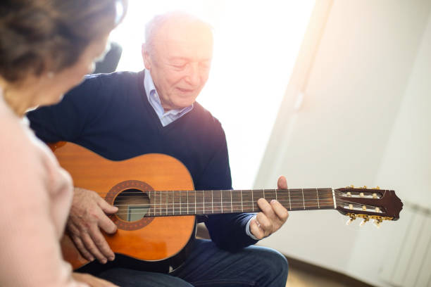 istock Senior man playing a guitar for his wife 1137517298