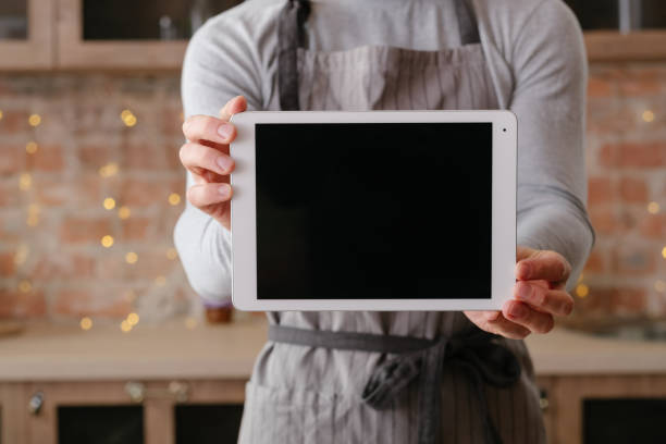 online recipe tablet screen man loft kitchen