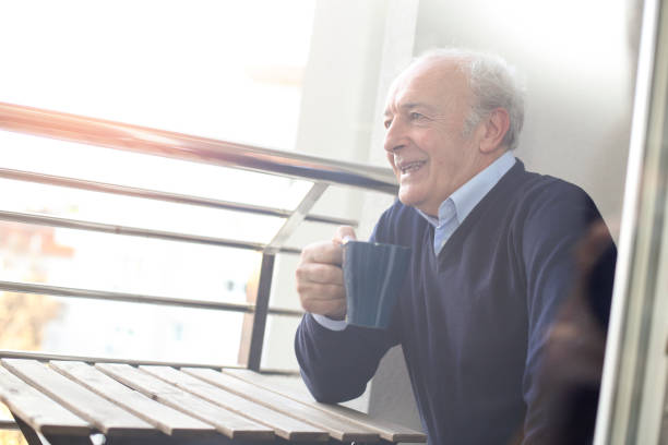 istock Senior man drinking tea on a balcony 1137518250