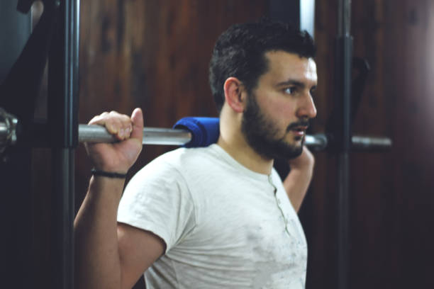 istock squat in the gym 1137518403