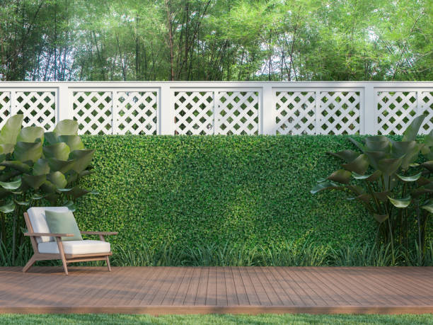Outdoor wood terrace in the garden 3d render Outdoor wood terrace in the garden 3d render,  There is a wooden floor terrace,white fence,furnished with wood and white fabric furniture. patio stock pictures, royalty-free photos & images
