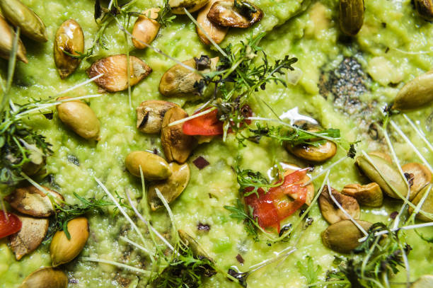istock guacamole with roasted peanuts, black background, top view 1137519596