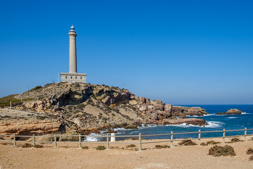 Cabo de Palos lighthouse, in Murcia, Spain, framed against a deep blue sky