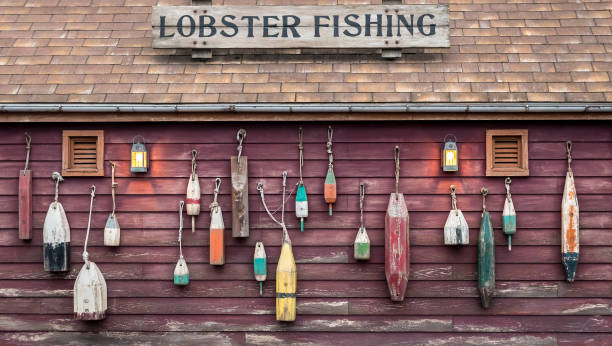 closeup of colorful floats hanging outside a lobster fisherman's cottage. - fishing hut imagens e fotografias de stock