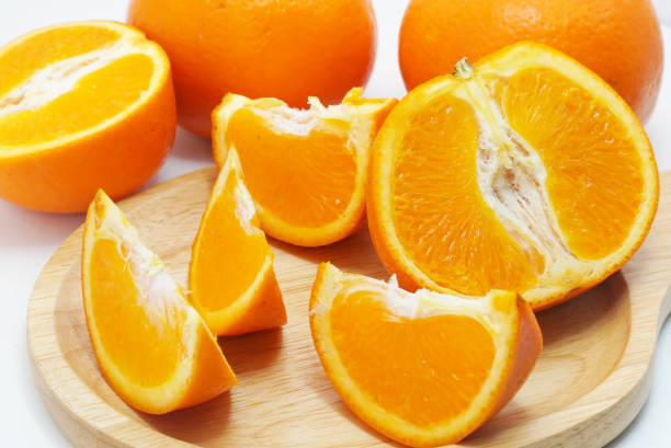 istock Group of slice oranges on wood plate 1137521175
