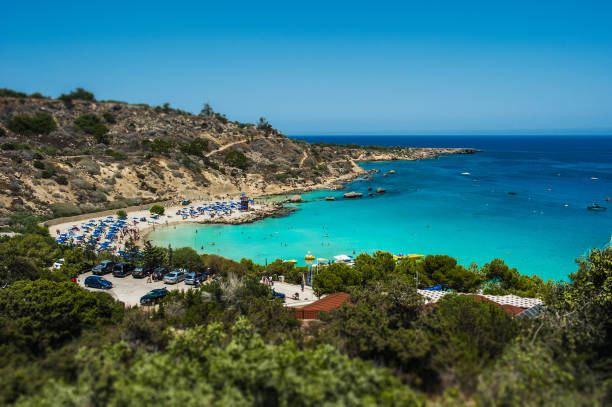 Beautiful beach in the blue lagoon on the sea. Seascape. Beautiful coast of Cyprus. Resort area in Cyprus. The Beaches Of Cyprus. Greek beaches. Paid beaches stock photo