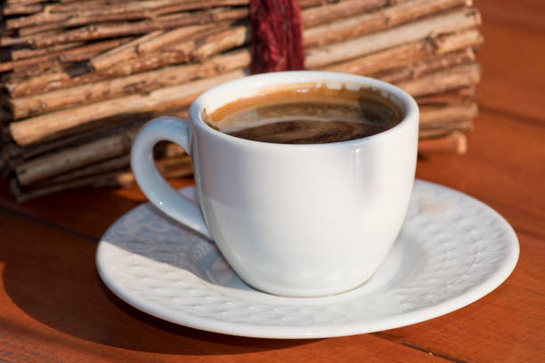 istock Coffee cup and beans, on wooden table 1137524617
