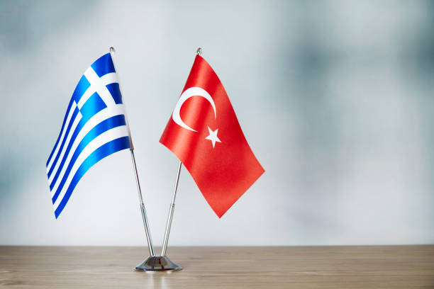 Greece and Turkish flag standing on the table