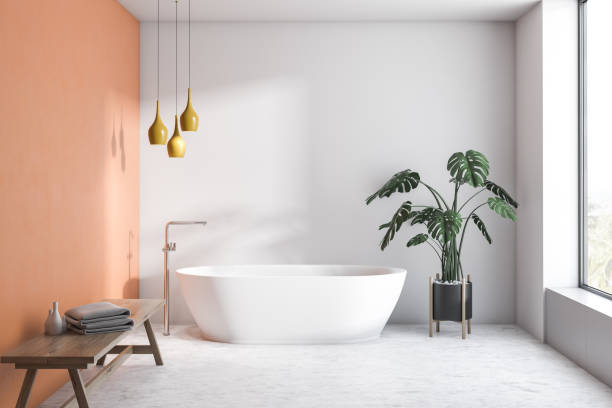 istock White and orange bathroom with white tub 1137525168