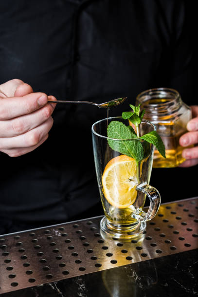 istock bartender prepares fruit tea with cranberries in a glass, dark background 1137525883