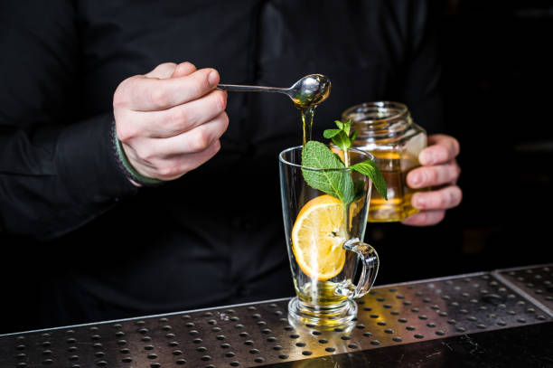 istock bartender prepares fruit tea with cranberries in a glass, dark background 1137525963