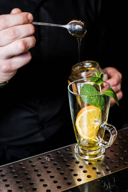 istock bartender prepares fruit tea with cranberries in a glass, dark background 1137526122