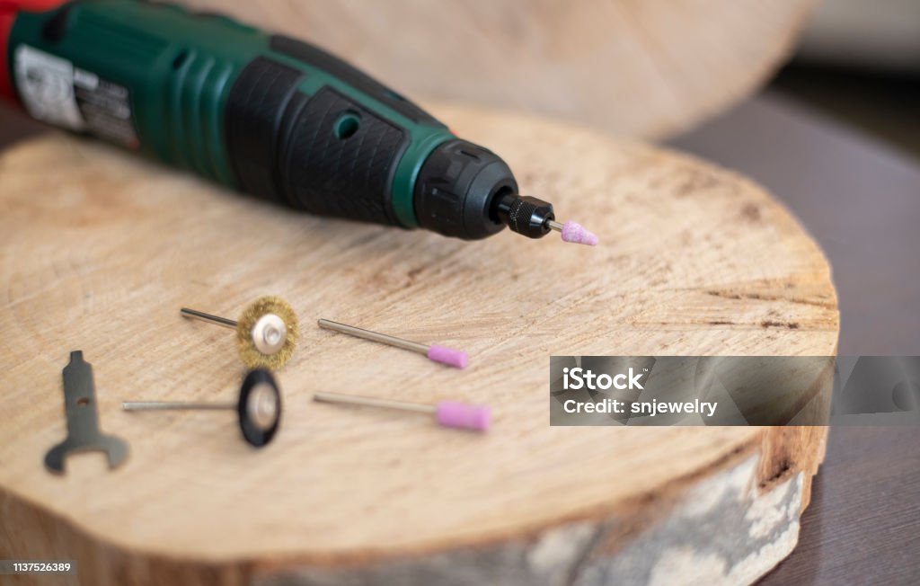Drill Rotary Tool With Accessories Dremel Tool Heads Multi Tool On Wooden  Table In Jeweler Workshop Close Up Of A Screwdriver With Sander Cone Drill  Bit Stock Photo - Download Image Now 