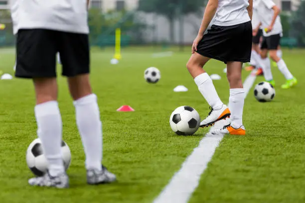 Football Training Practice Exercises for Youth Soccer Players. Boys on Training with Soccer Balls on Pitch