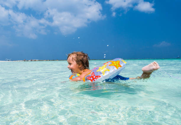 istock Joyful  little boy enjoying while swimming in inflatable ring at sea. 1137528548
