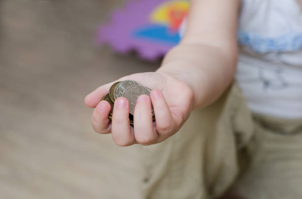 istock little girl is playing with coins 1137530135