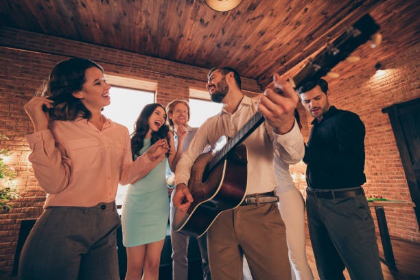 istock Company of nice-looking lovely charming elegant classy chic cheerful ecstatic positive guys ladies having fun birthday event disco solo guitar player in industrial loft interior room indoors 1137530232
