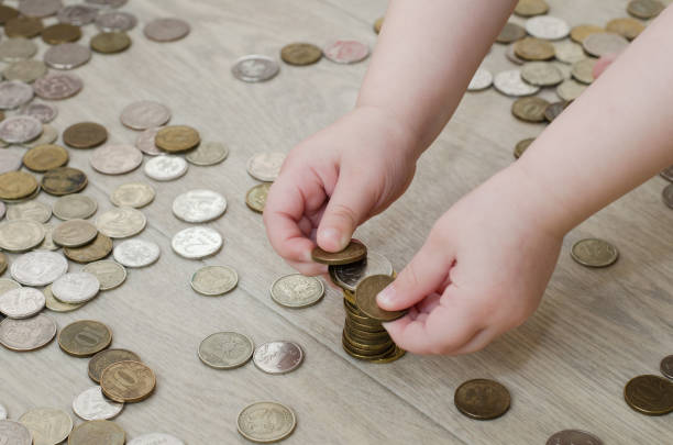 istock little girl is playing with coins 1137530350