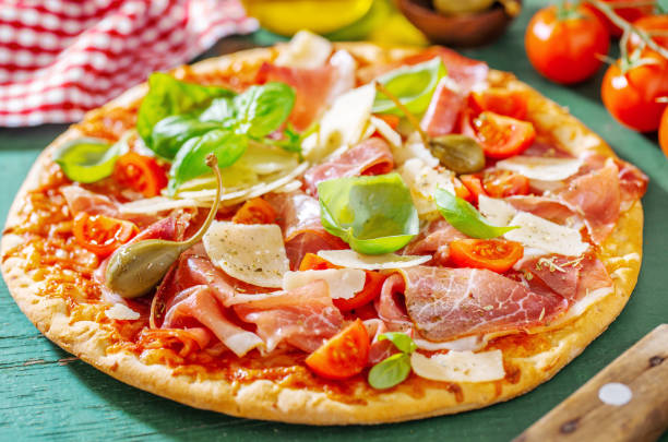 istock Appetizing italian pizza with prosciutto 1137530483