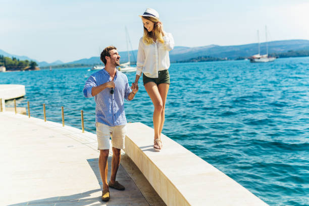 istock Young tourists couple on walk along the port 1137533367