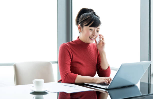 istock Woman using smart phone and laptop in office 1137539591