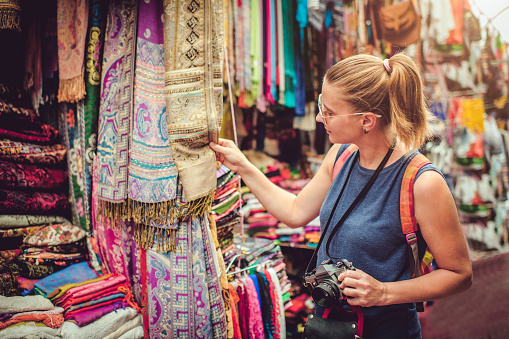 Beautiful woman discover gifts market while travelling Middle East