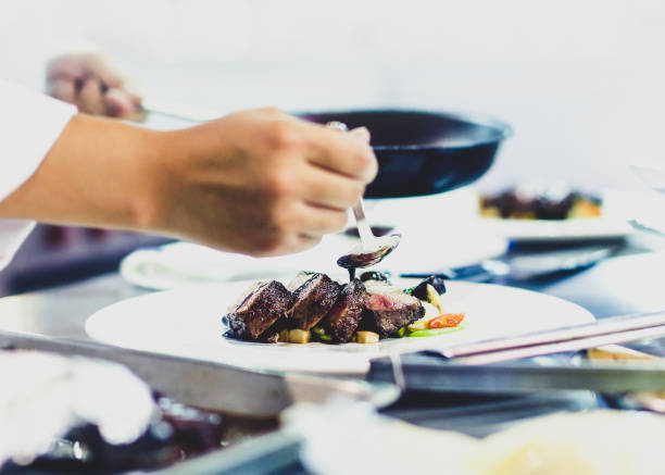 istock Chef preparing food, meal, in the kitchen, chef cooking, Chef decorating dish 1137540796