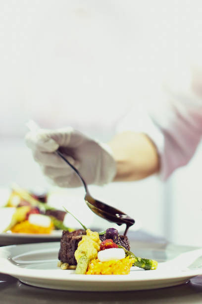 istock Chef preparing food, meal, in the kitchen, chef cooking, Chef decorating dish 1137540797