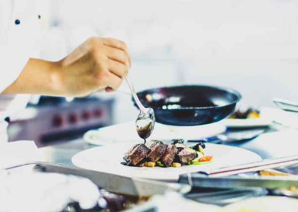 istock Chef preparing food, meal, in the kitchen, chef cooking, Chef decorating dish 1137540798