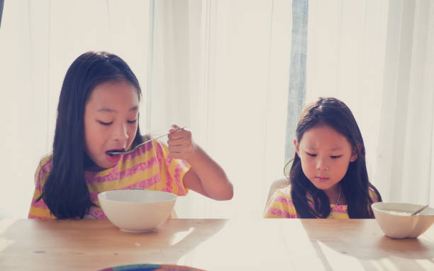 istock Cute Asian girl eats rice soup for breakfast 1137541893