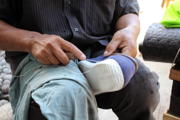 istock Process of manual shoe reparation, sole and welt fixing and stitching. 1137541920