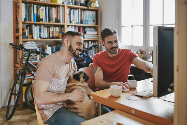 istock Gay men with pet looking at computer monitor 1137542155