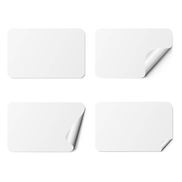 Set of white rectangle adhesive stickers with a folded edges, isolated on white background. Set of white rectangle adhesive stickers with a folded edges, isolated on white background. blank sticker stock illustrations