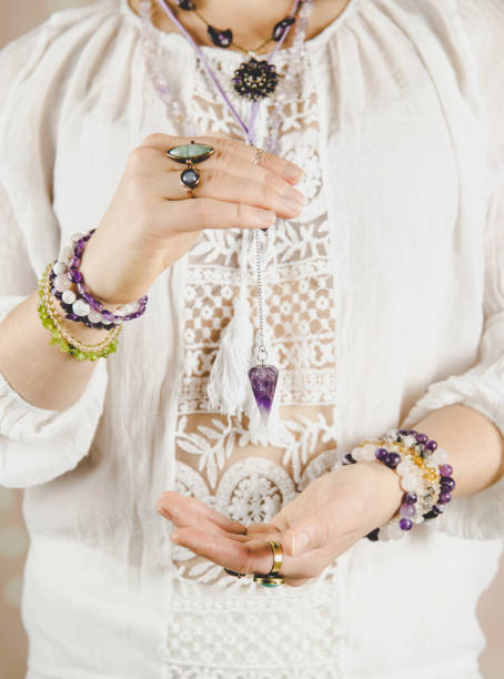 istock Light angel magic clairvoyant using pendulum, reading palm to get answers. Talking with spirits concept. 1137545852