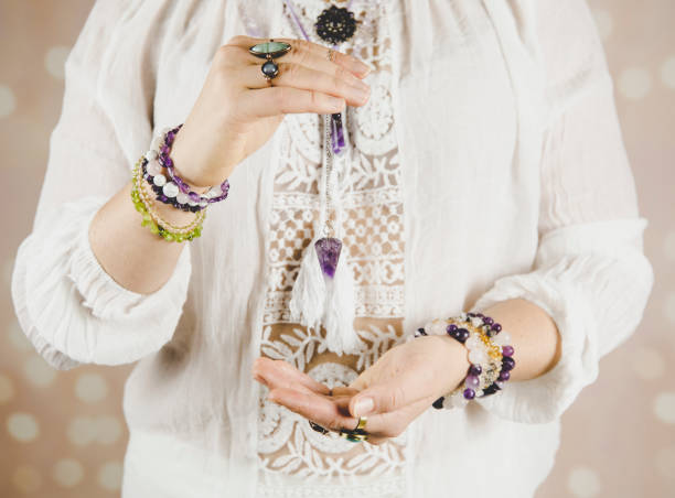 istock Light angel magic clairvoyant using pendulum, reading palm to get answers. Talking with spirits concept. 1137545854