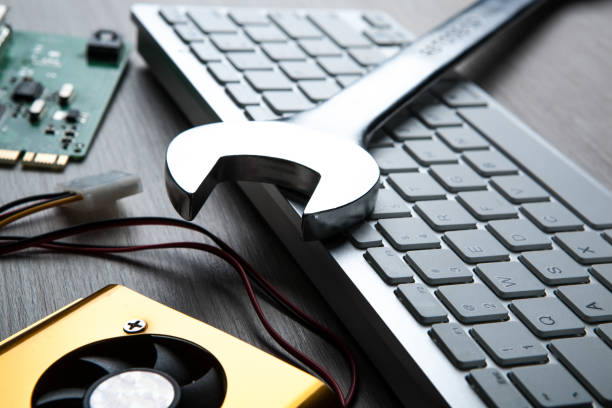 istock big wrench and a computer keyboard and computer parts close up 1137545857