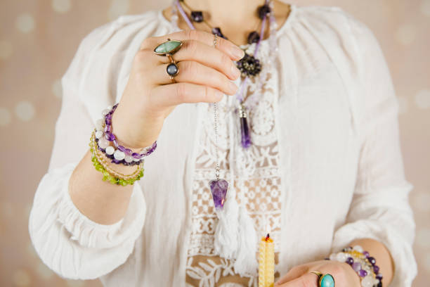 istock Light angel magic clairvoyant using crystal pendulum, reading palm to get answers. Talking with spirits concept. 1137545858
