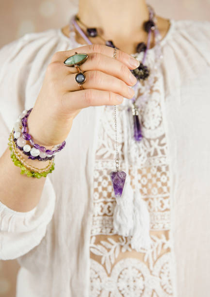 istock Light angel magic clairvoyant using pendulum, reading palm to get answers. Talking with spirits concept. 1137545861