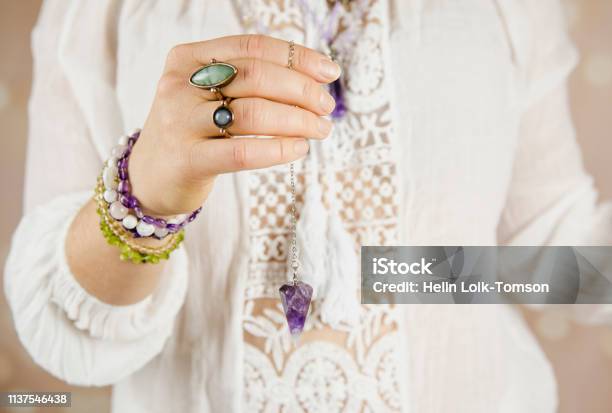 Light Angel Magic Clairvoyant Using Pendulum Reading Palm To Get Answers Talking With Spirits Concept Stock Photo - Download Image Now