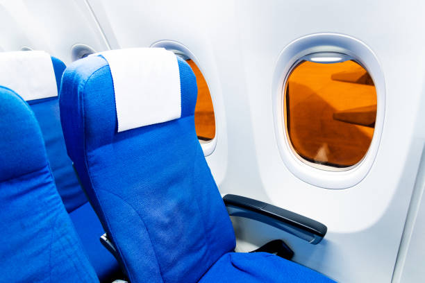 Empty seat by the window of an airplane.