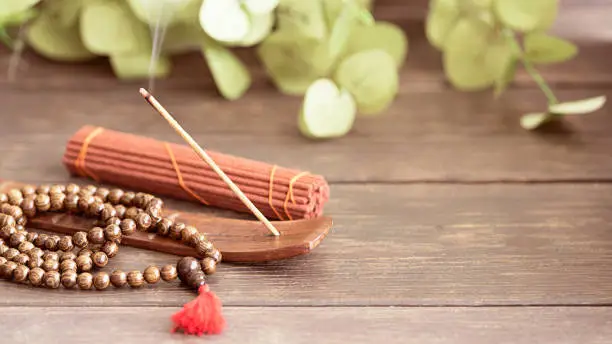 Stick holder with  burning incense stick  and mala beads for meditation and relax.