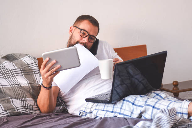 istock Young man working early in bed on a laptop 1137549176