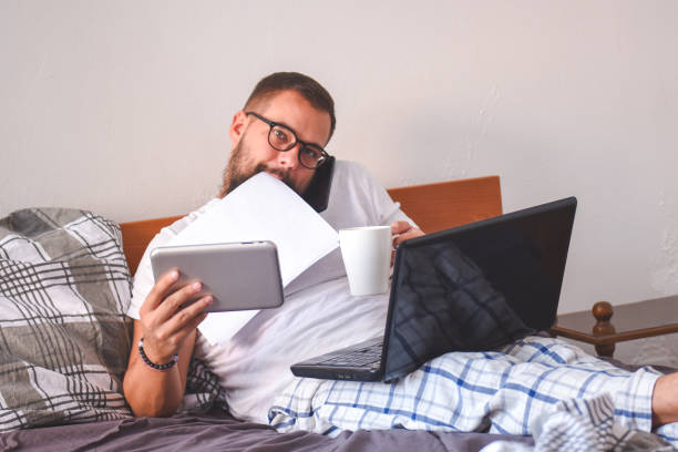 istock Young man working early in bed on a laptop 1137550394